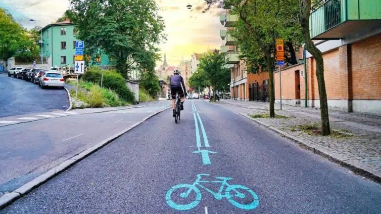 A man riding a bike in Germany on a city cycleway