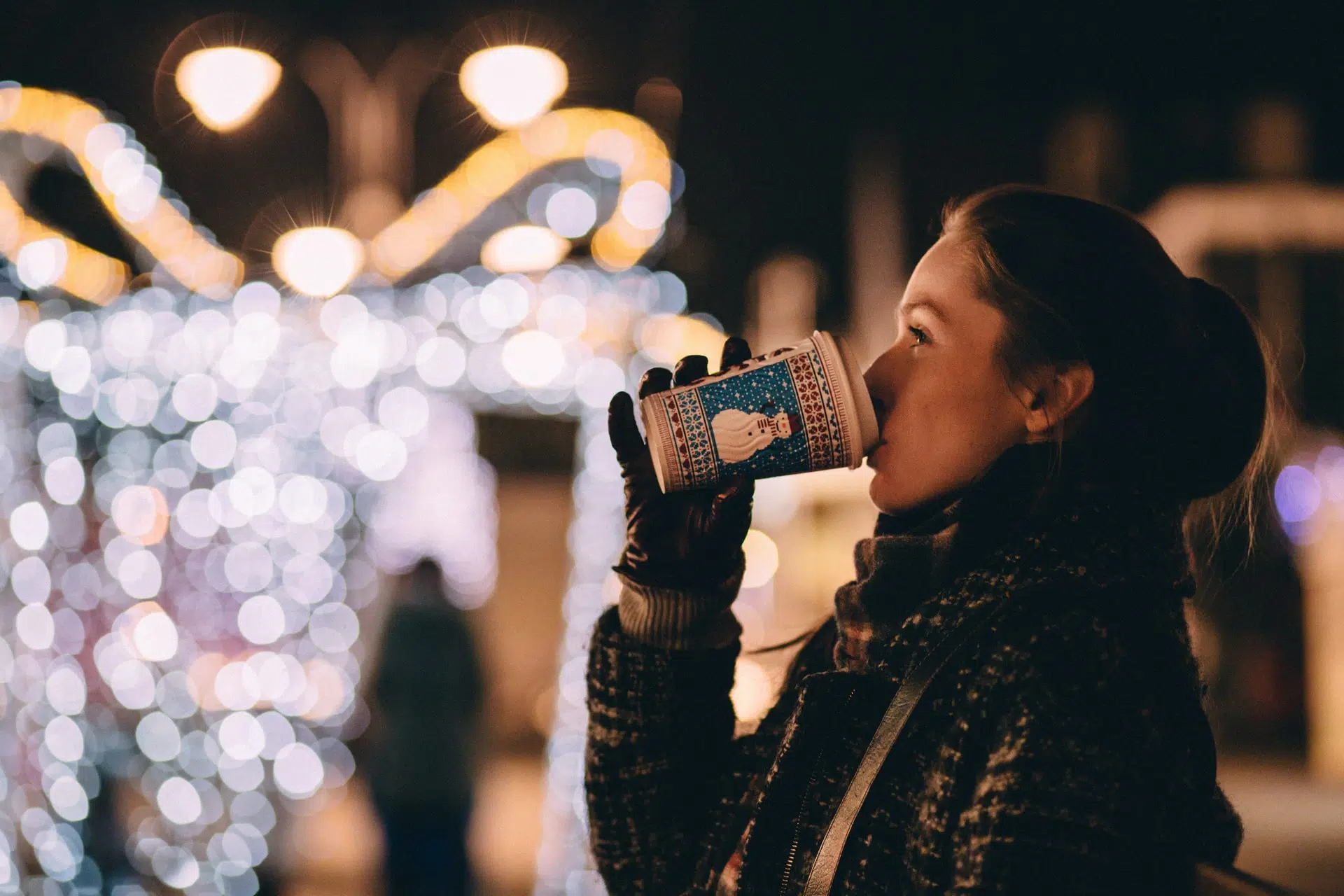 A woman drinking Christmas coffee