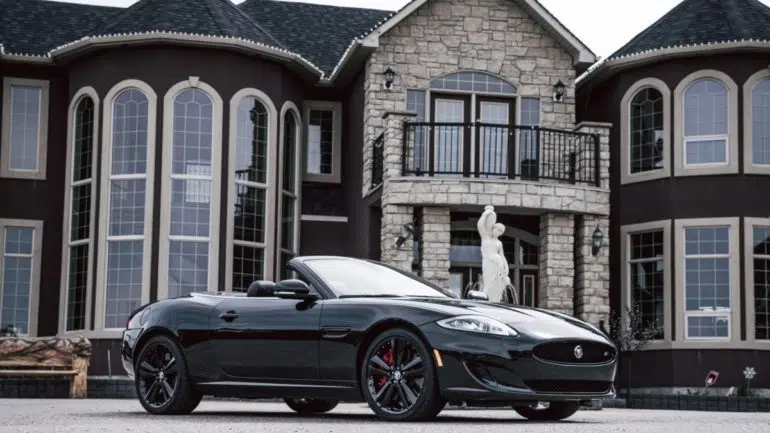 A car in front of a luxury house