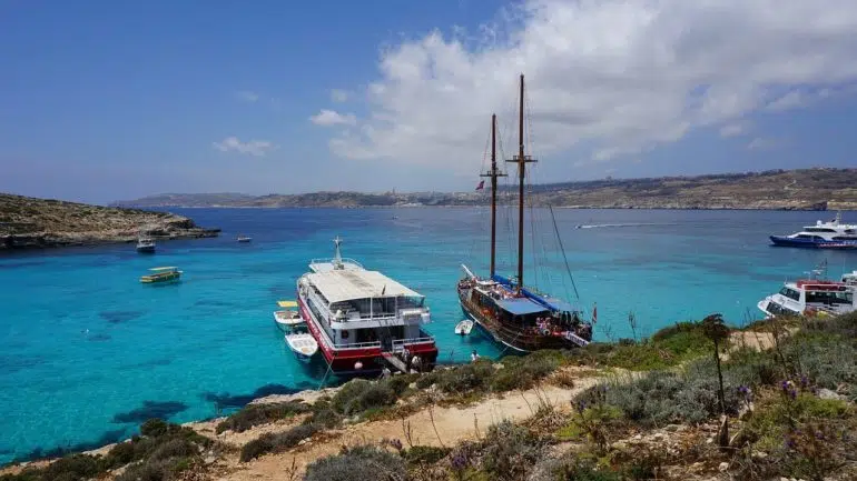 Boats on the Comino's Blue Lagoon beach