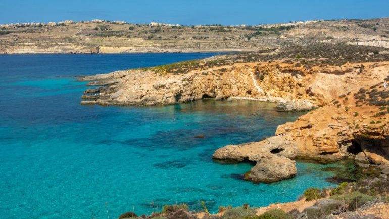 A view of the Comino's Blue Lagoon rocky beach and crystal waters