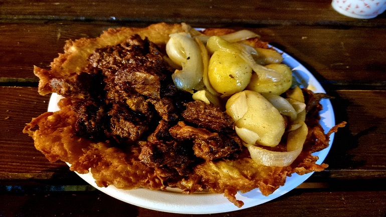 Hungarian pulled pork with potatoes over a potato pancake at Budapest Advent Bazilika Christmas market