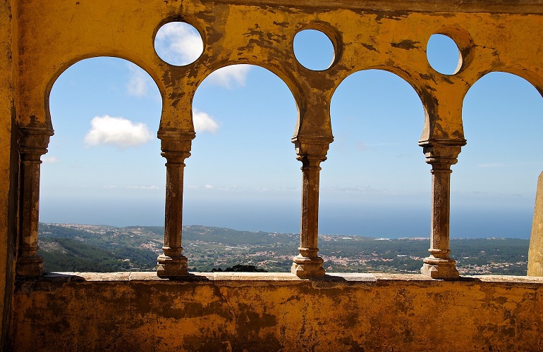 View from a Pena Palace terrace with yellow archways.